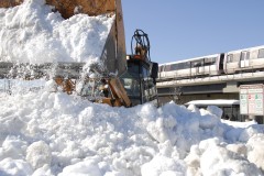 A frontloader clears snow at the Rhode Island Ave - Brentwood Metro station (courtesy Larry Levine/WMATA)